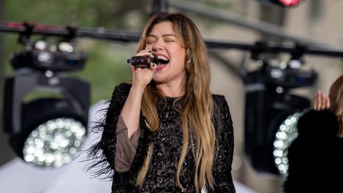 Kelly Clarkson performing on stage